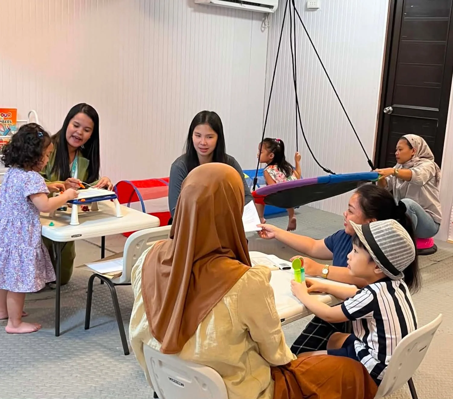 A child celebrating a milestone during therapy at Little BLOOM