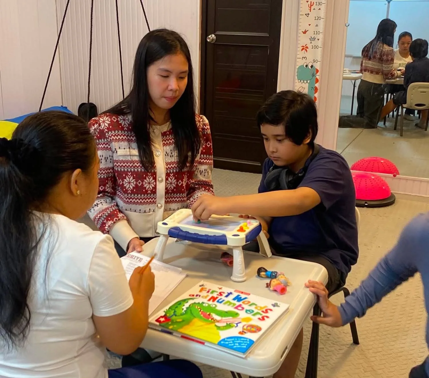 Child working through a speech and play therapy session at Little BLOOM